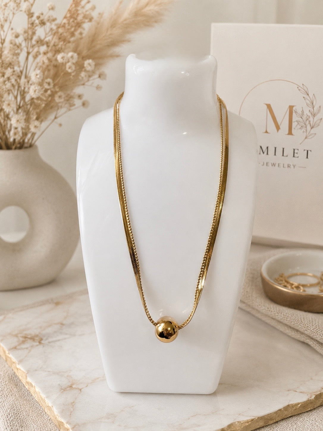 Gold Herringbone Necklace with sphere slider on white bust display